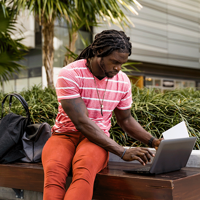 Man using laptop outside