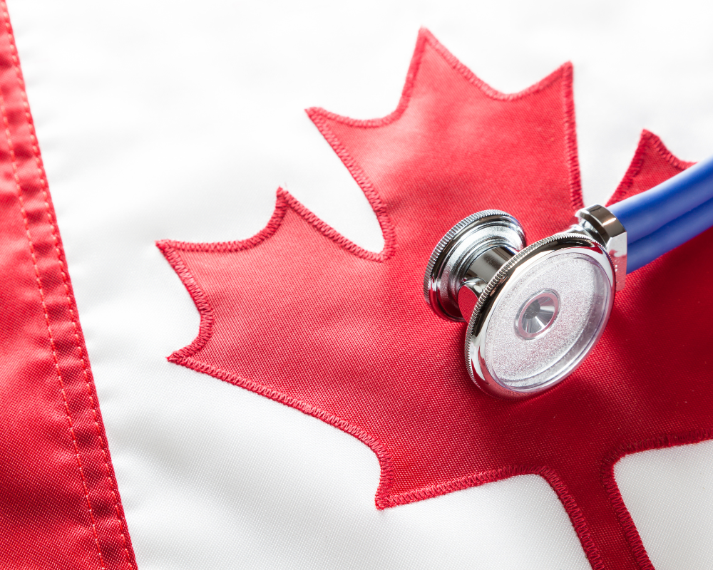 A stethoscope rests on a Canadian flag.